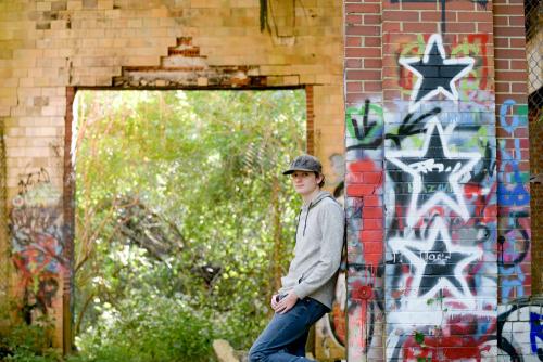 senior boy in abandoned building with graffiti senior portrait by Krista Nutter Photography Cincinnati