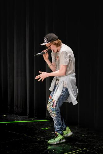 senior boy hip hop rapper performing with microphone on stage senior portrait by Krista Nutter Photography Cincinnati