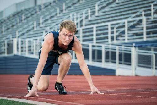senior boy track runner in his starting stance sports portrait by Krista Nutter Photography Cincinnati