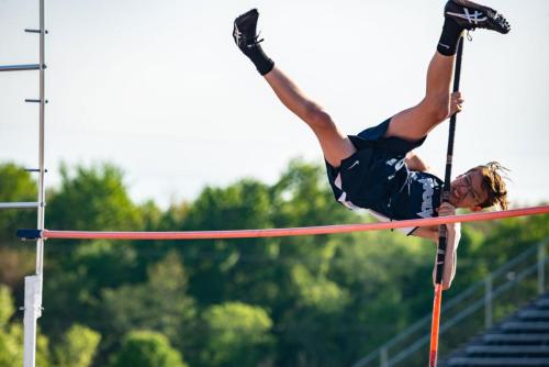 senior boy going over pole vault senior sport portrait by Krista Nutter Photography Cincinnati