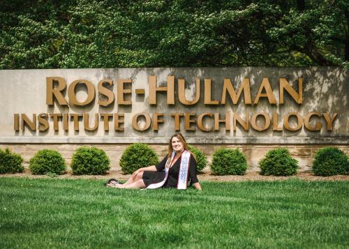 college senior girl sitting in front of the Rose-Hulman Institute of Technology campus entrance sign senior portrait by Krista Nutter Photography Cincinnati